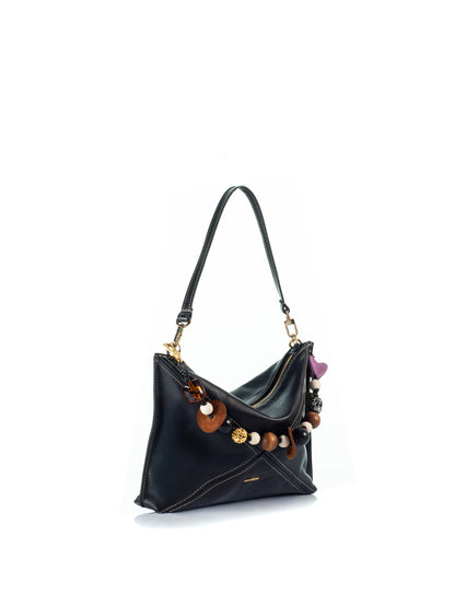 Side view of the KOORELOO Chatterbox Black Leather shoulder bag with handcrafted multicolor charms, beads and gold-tone hardware