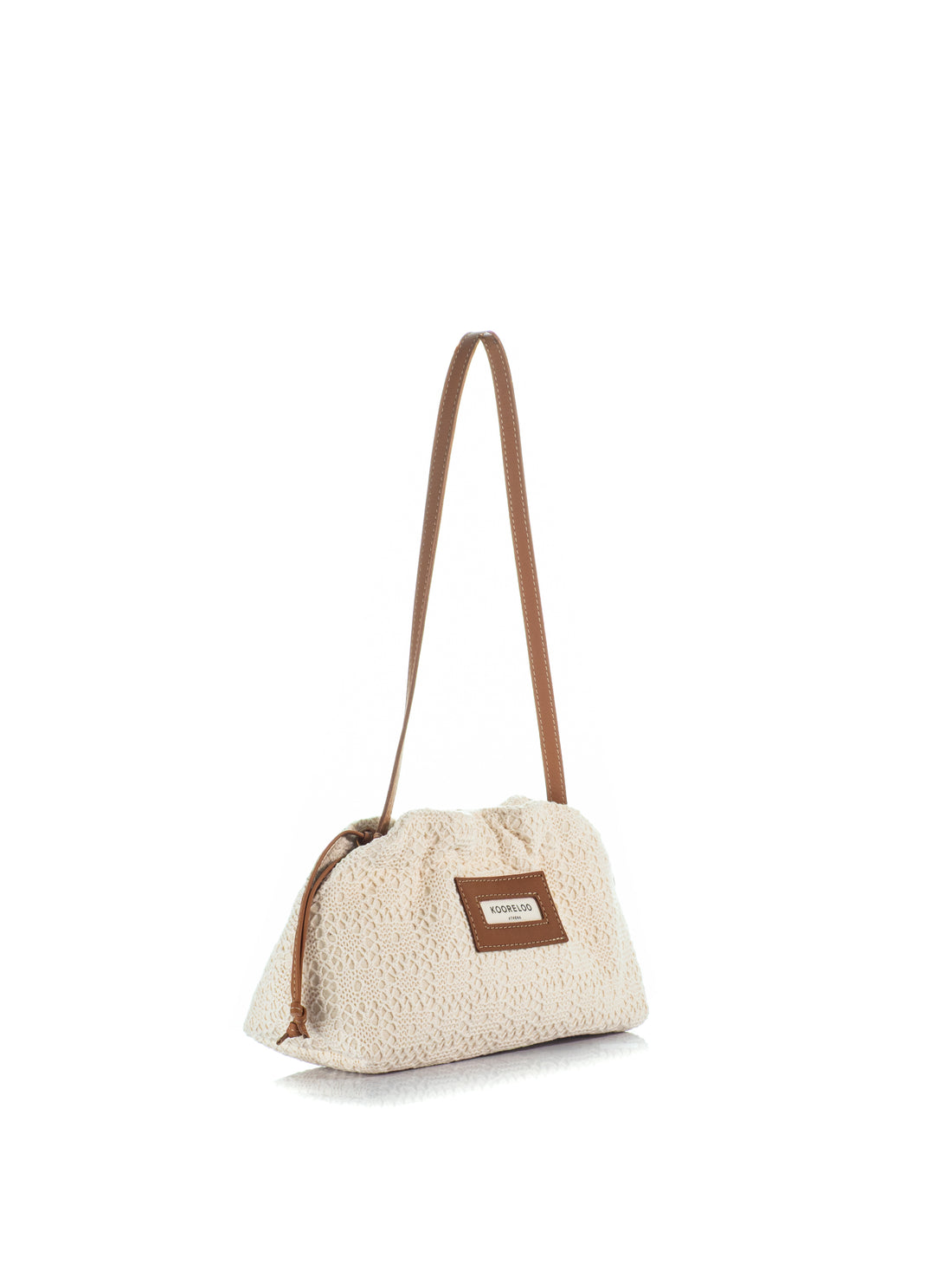 Side view of the Kooreloo Milano Pouch Mini handbag in ivory crochet with brown leather strap on a white background