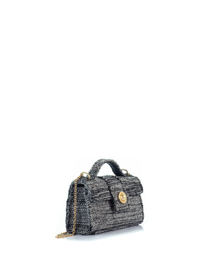 Side view of the KOORELOO The Noble Mini Grey Woven Fabric handbag with top handle, gold-tone front detail and chain strap